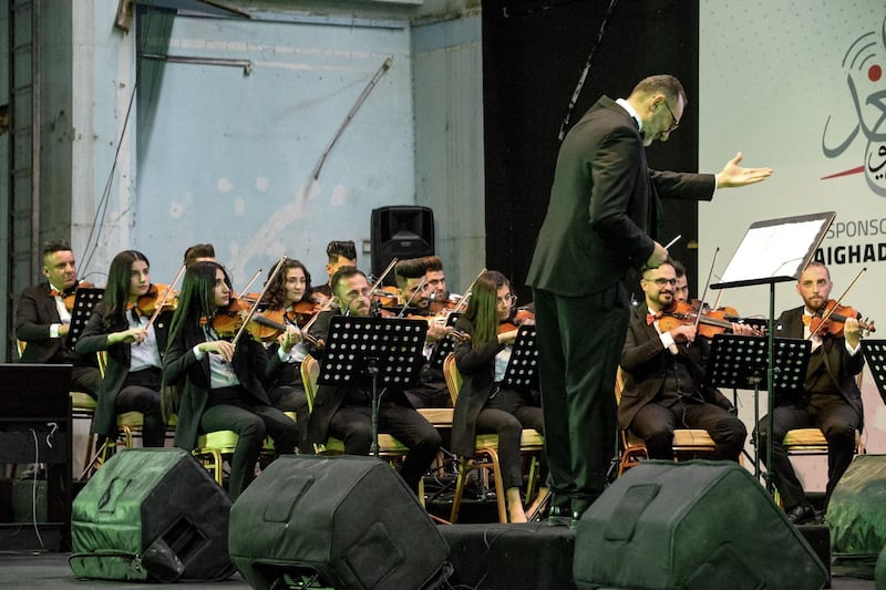 Conductor Mohammed Mahmoud leads the Watar orchestral ensemble at the Al Rabea Theatre in Mosul, which was destroyed during the war against ISIS. AFP