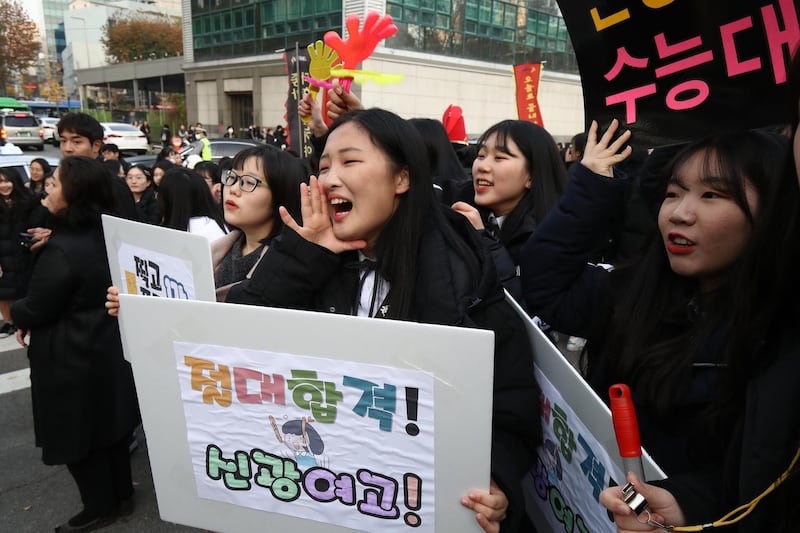 South Korean high school girls cheer for their senior classmates in Seoul, South Korea. Getty Images