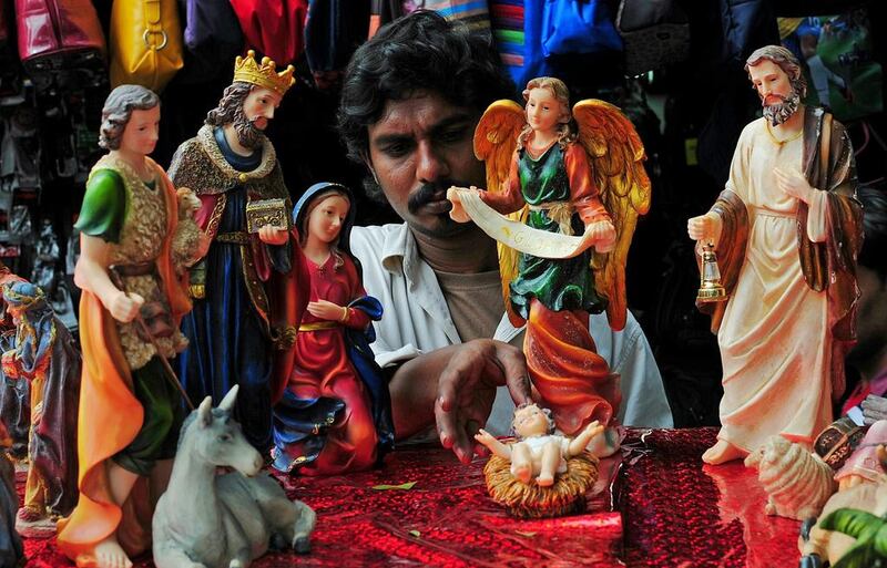 An Indian shop keeper arranges a nativity scene at his store in Bangalore, India.  Jagadeesh NV / EPA