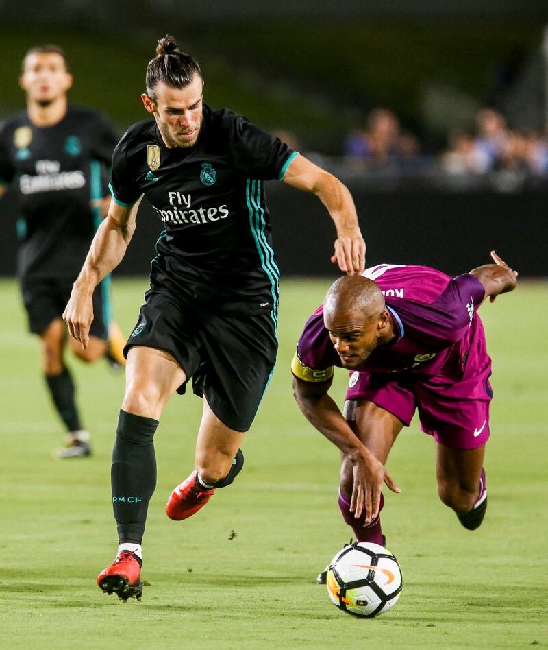 Real Madrid's Gareth Bale battles with Manchester City defender Vincent Kompany  during their International Champions Cup pre-season friendly match at the Los Angeles Memorial Coliseum in July 2017. AFP