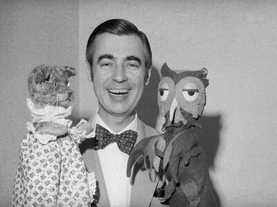 Fred Rogers of Mister Rogers' Neighborhood holds Henrietta Pussycat (left) and "X" the Owl during an interview. Rogers is an ordained Presbyterian minister and his ministry works to reach out to children and their families through mass media. Getty Images