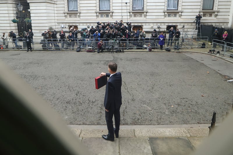 Mr Hunt presents the budget box to the waiting media in Downing Street. Photo: No 10 Downing Street