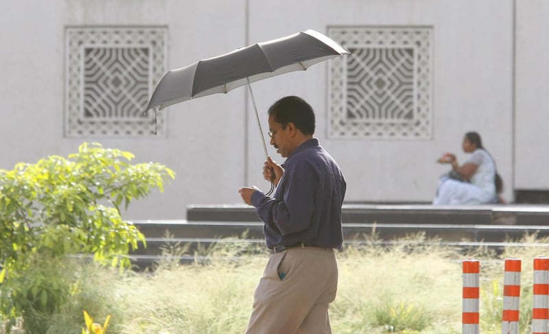 Dubai, 17th June 2010.  As mercury rises, this man makes good use of the umbrella, at Al Ghubaiba-Bur Dubai.  (Jeffrey E Biteng / The National)