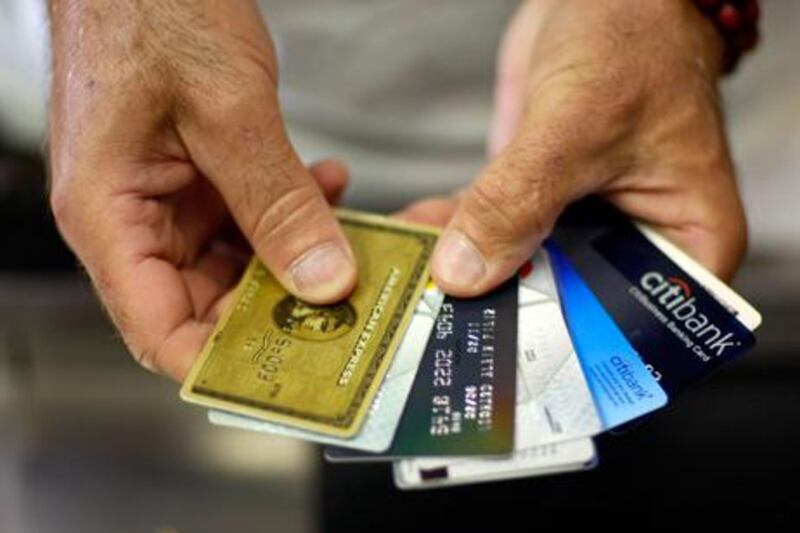 A new survey has found cash-strapped residents in the UAE are using their credit cards to pay their loan obligations. Joe Raedle/Getty Images/AFP