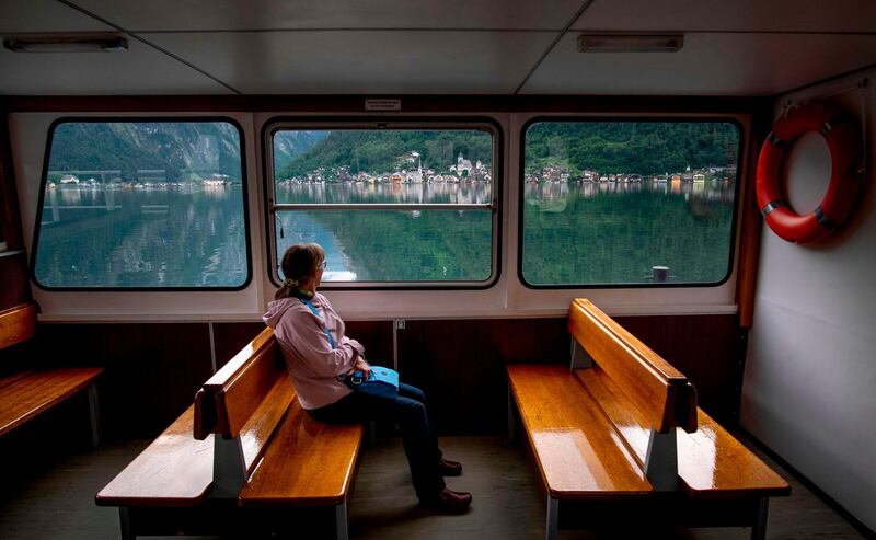 A lonely passenger rides the river ship connecting the train station to the village. AFP