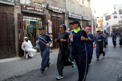 Saudi women jog in the streets of Jeddah's historic al-Balad district on March 8, 2018.
Colourful and oozing defiance, a sports-friendly version of the abaya gown was once considered a symbol of cultural rebellion in conservative Saudi Arabia, but it is fast becoming the new normal. / AFP PHOTO / Amer HILABI