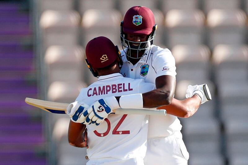 Jason Holder and John Campbell celebrate after clinching victory. AFP