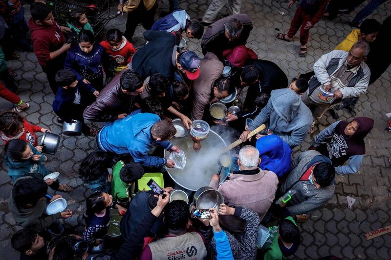 Palestinian Walid al-Hattab, widely known as 'the chef to the poor', distributes soup to people in need in Gaza City during Ramadan. AFP