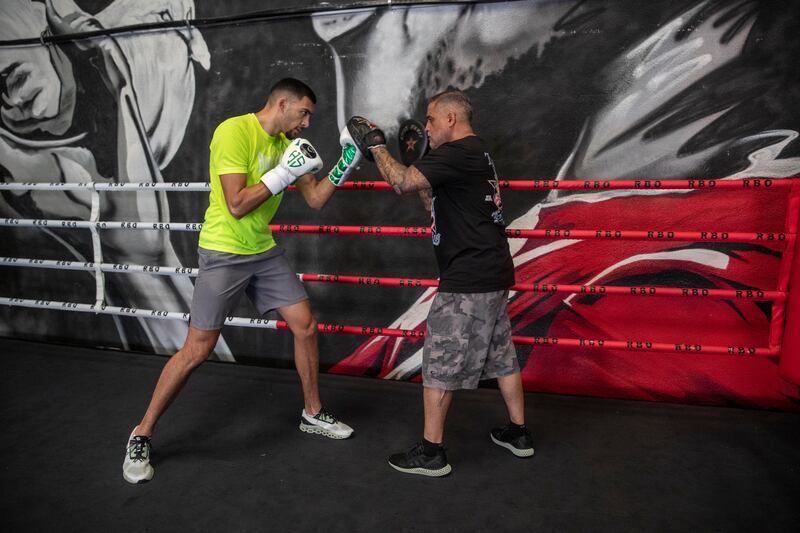 Hamzah Sheeraz hits the pads with trainer Ricky Funez at the Real Boxing Only Gym. Antonie Robertson / The National