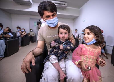 Families wait at the medical clinic in Emirates Humanitarian City in Abu Dhabi. Victor Besa/The National