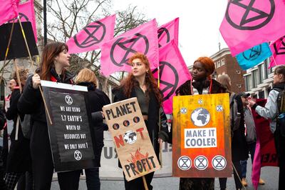 People gather in central London for an Extinction Rebellion protest during London Fashion Week, in London Saturday Feb. 15, 2020. The environmental pressure group Extinction Rebellion are targeting what they allege is the global impact from the ephemeral fashion industry.(Katie Collins/( / PA via AP)