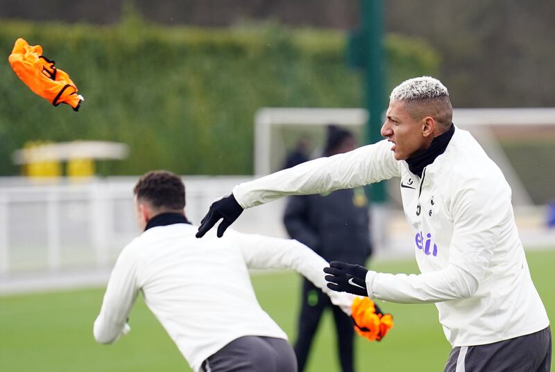 Tottenham Hotspur's Richarlison throws away a bib during a training session. PA