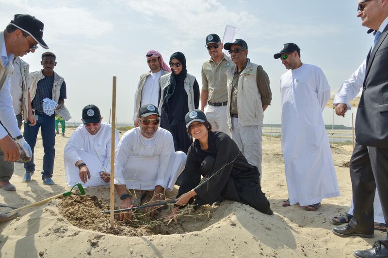 Razan Al Mubarak, Environment Agency-Abu Dhabi secretary general, and Adel Albuainain, chief executive of Dolphin Energy, planting the trees at Al Wathba Wetland Reserve. Courtesy EAD