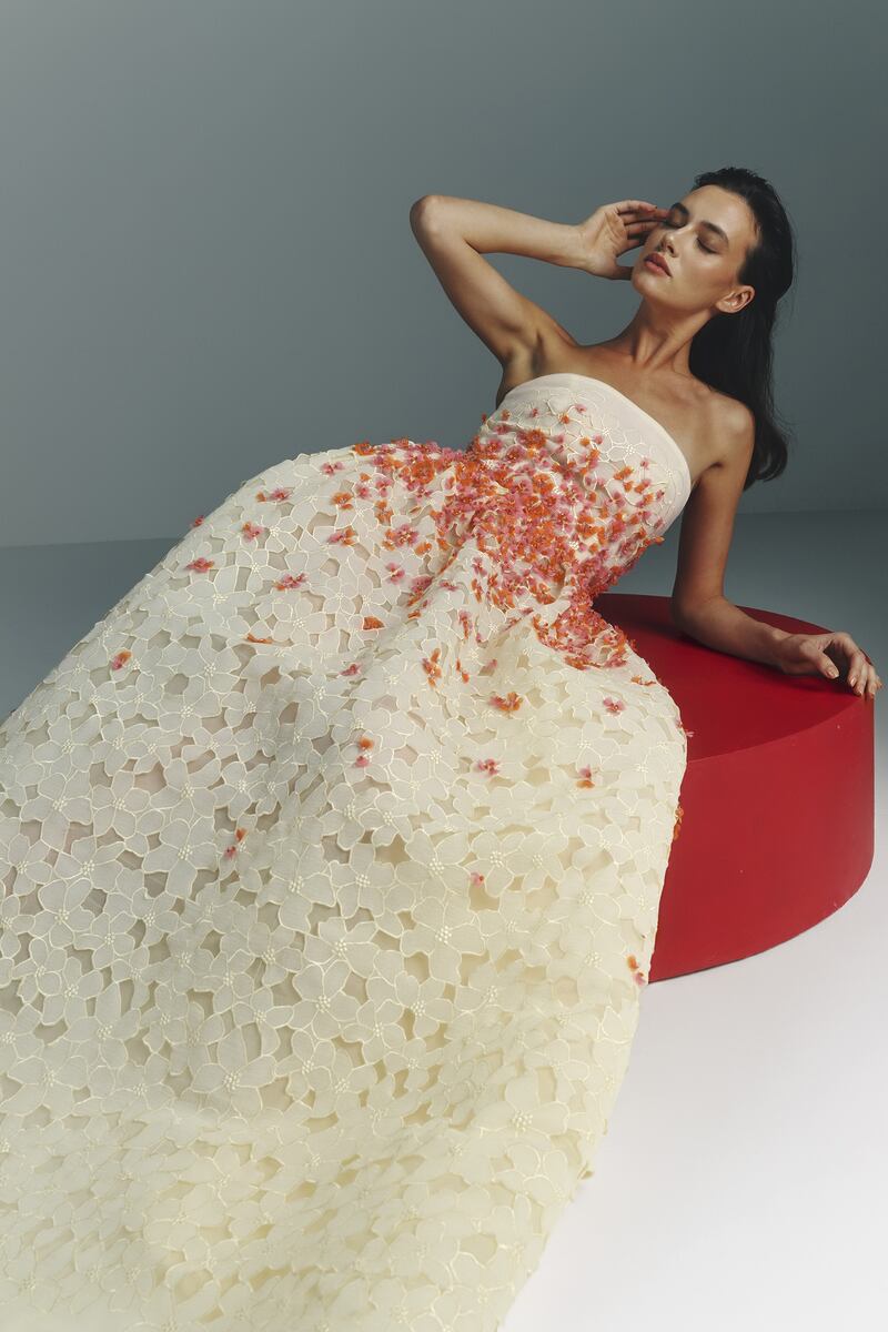 An ivory-cut gown is decorated with wisps of chiffon