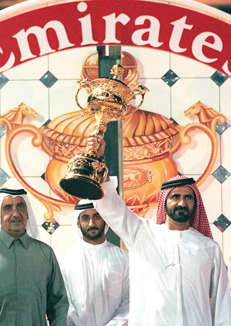 Sheikh Mohammed bin Rashid raises the Dubai World Cup in 1997 after his maiden success in the race with Singspiel. AFP