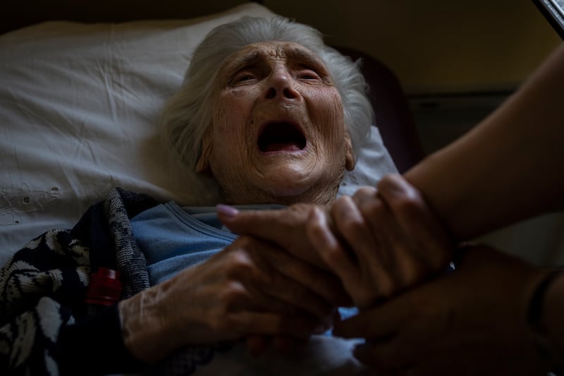 An elderly woman, who was evacuated from the Lysychansk area, cries moments before travelling by train to western Ukraine from Pokrovsk railway station. AP