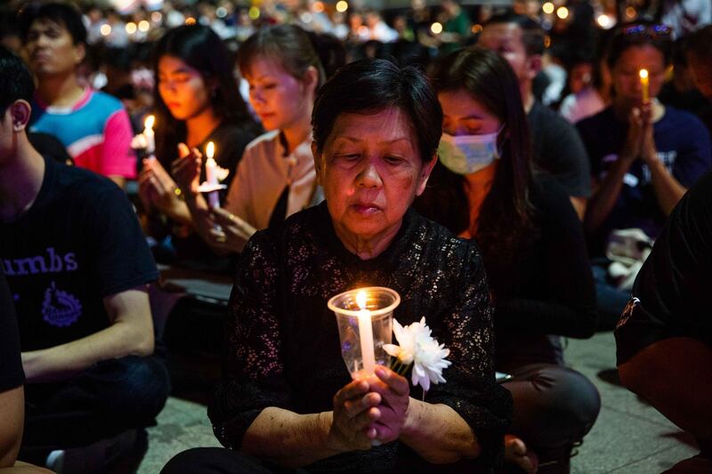 Thai mourners attend a candlelight vigil for the victims of the Terminal 21 Mall shooting on February 9, 2020 in KORAT, Thailand. Getty Images