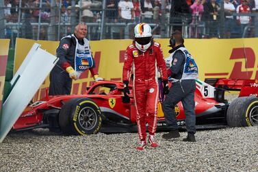 Ferrari's Sebastian Vettel walks from his car after crashing during the German Grand Prix at Hockenheim in 2018. Getty