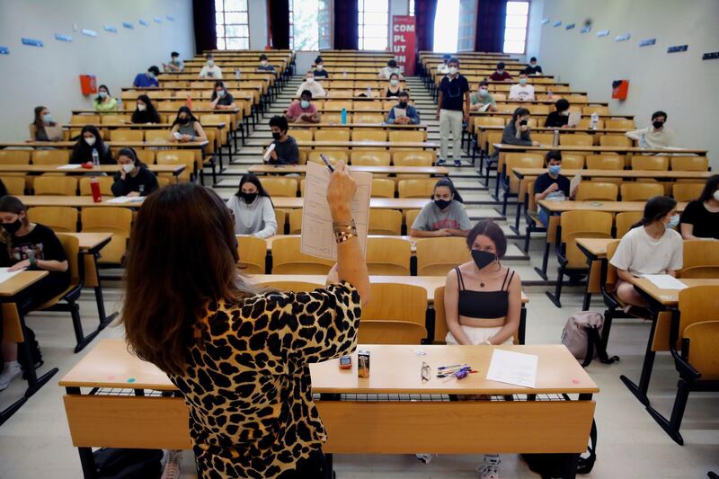 Socially distanced students listen to instructions before they take their university entrance exams in Madrid, Spain. EPA
