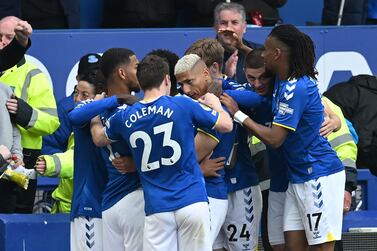 Everton's Brazilian striker Richarlison (C) celebrates with teammates after scoring the opening goal of the English Premier League football match between Everton and Chelsea at Goodison Park in Liverpool, north west England on May 1, 2022.  (Photo by Paul ELLIS / AFP) / RESTRICTED TO EDITORIAL USE.  No use with unauthorized audio, video, data, fixture lists, club/league logos or 'live' services.  Online in-match use limited to 120 images.  An additional 40 images may be used in extra time.  No video emulation.  Social media in-match use limited to 120 images.  An additional 40 images may be used in extra time.  No use in betting publications, games or single club/league/player publications.   /  