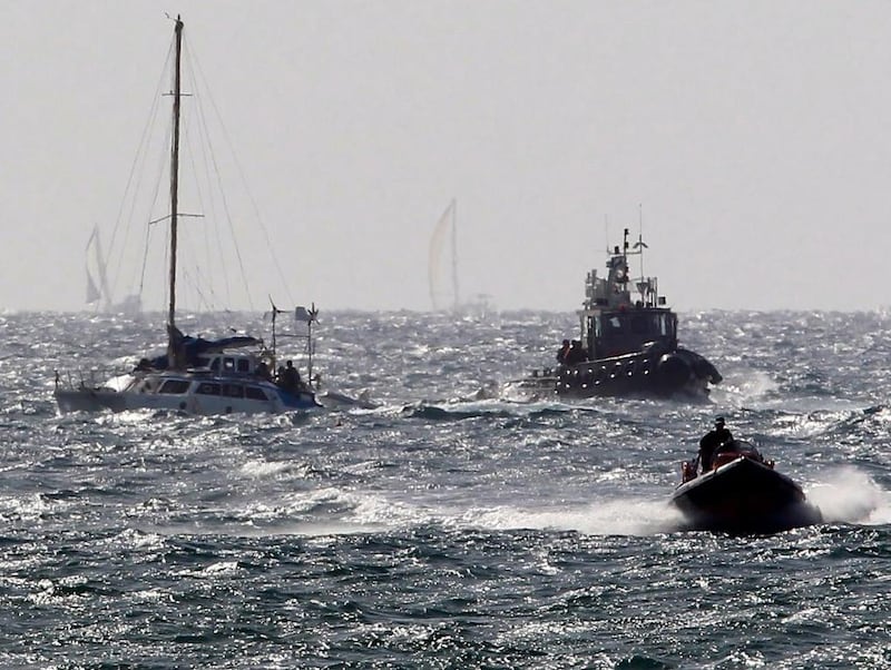 One of the boats that took part in the previous attempt to break Israel's blockade of Gaza is escorted by Israeli naval vessels to Ashdod. Jim Hollander / EPA