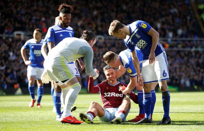 Aston Villa's Jack Grealish sits on the floor after being attacked by a fan. Reuters