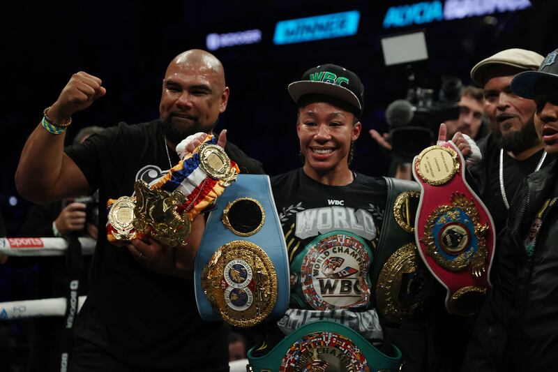 Alycia Baumgardner celebrates with the IBF, IBO, WBC and WBO Super Featherweight World Title belts. Getty