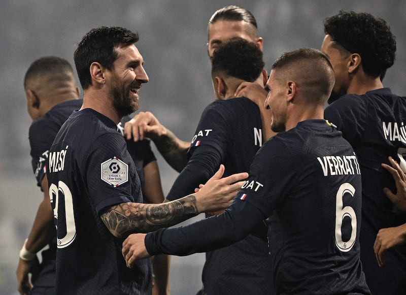 Paris Saint-Germain's Lionel Messi is congratulated by teammates after scoring against Lyon. AFP