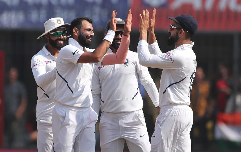 India bowler Mohammed Shami, second left, celebrates after taking the wicket of Bangladesh's Mohammad Mithun. AP