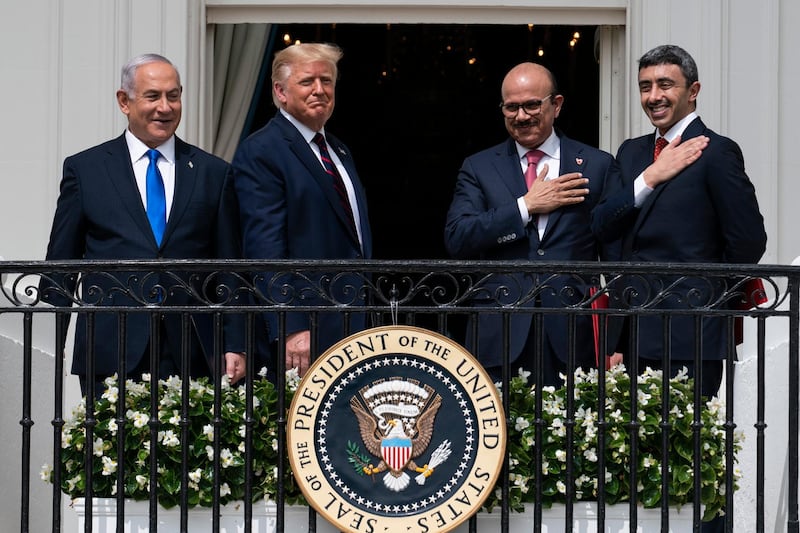 FILE - In this Tuesday, Sept. 15, 2020 file photo, Israeli Prime Minister Benjamin Netanyahu, left, President Donald Trump, Bahrain Foreign Minister Khalid bin Ahmed Al Khalifa and United Arab Emirates Foreign Minister Abdullah bin Zayed al-Nahyan react on the Blue Room Balcony after signing the Abraham Accords during a ceremony on the South Lawn of the White House in Washington. Jewish American voters have leaned Democratic for decades, but the GOP is still eyeing modest gains with the constituency in states where President Donald Trump could reap major benefits with even small improvements over his performance in 2016. (AP Photo/Alex Brandon)