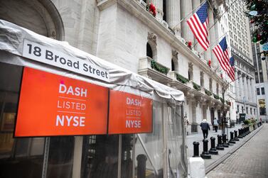 DoorDash signs hang outside the New York Stock Exchange, where the company made its stock market debut. On Wednesday, shares opened 84% above its opening price. Bloomberg