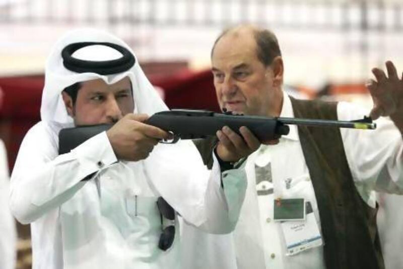 A visitor tries out a rifle at last year's Adihex. Ravindranath K / The National