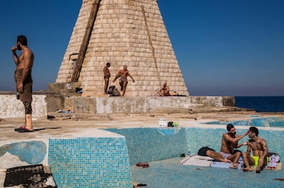 A group of men enjoy the sun at A.U.B. Beach.<br>

Beirut, Lebanon - March 6, 2015


A.U.B. beach consists of a pool and a concrete area located beside the Corniche, a famous seaside promenade in downtown Beirut. The beach is owned and managed by the American University and is officially open from May through March where activities and infrastructures are provided. 

Two hours away from this California look alike, fighting is raging in Ras Baalbeck with the Syrian civil war spilling over the border into Lebanon. On February 27th, at the time this photo-essay was shot, the Lebanese Army took part in a vast offensive against Syrian jihadists which resulted in 5 Lebanese soldiers wounded and dozens of Syrian militants killed.

In the winter months, the beach is occupied by local residents who come here daily to enjoy a swim and sun tan.

Abu Khodor, a prominent member of the sun tanners community has been coming to A.U.B. Beach every day for the past twenty-five years and even recalls swimming while the Israeli Army was bombing the city in 2006. He is held in high regard by the A.U.B. Beach community.

Most of those beach goers are devout Muslims and it is not rare to see them praying wearing exclusively a swimsuit; a behavior that seems far away from the Islamic States brutal interpretation of Islam.

Photo by Vianney Le Caer. NOTE: For Nick Leech's story