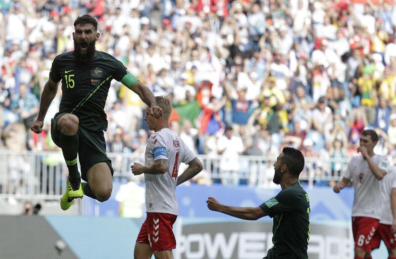 Australia's Mile Jedinak, left, celebrates scoring his side's opening goal. Gregorio Borgia / AP Photo