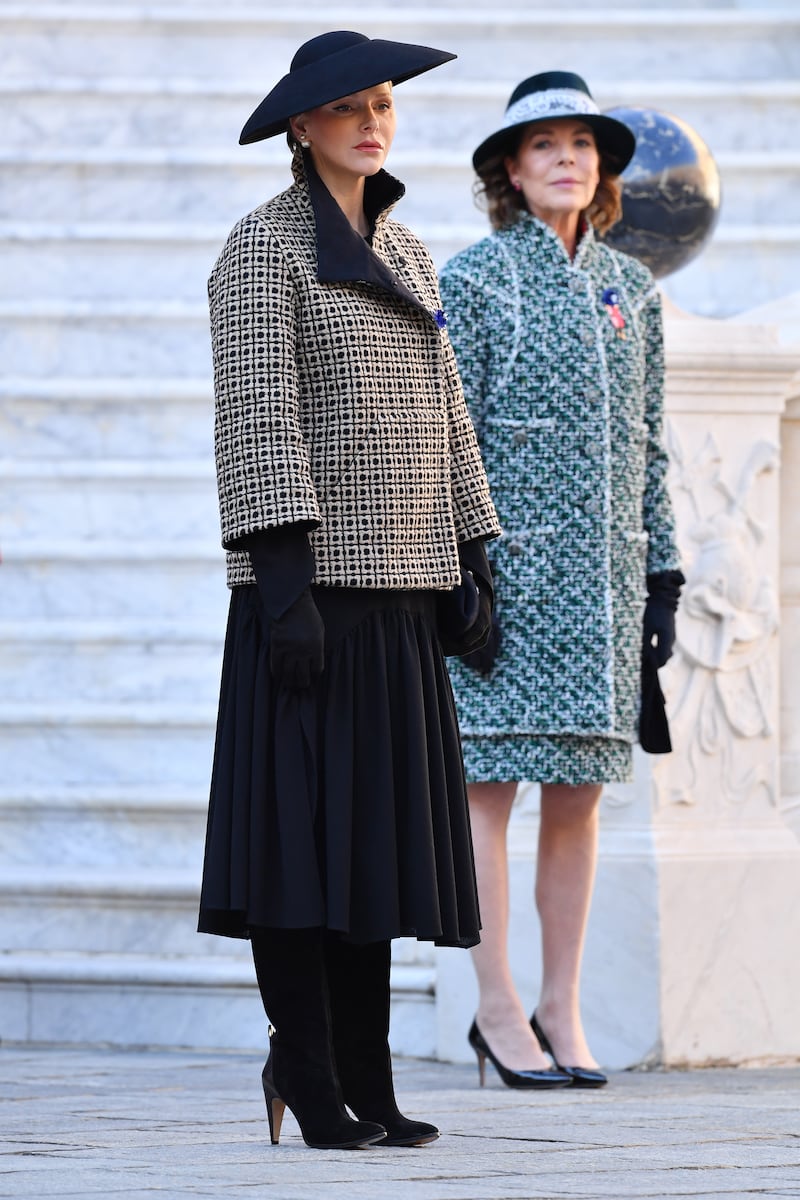 Princess Charlene, in a custom Akris monochrome coat and black hat, with Princess Caroline of Hanover, attends the Monaco National Day Celebrations on November 19, 2018. Getty Images