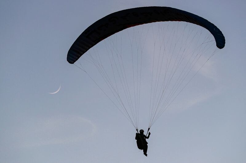 Members of the Sulaymaniyah paragliding team launch at sunset from Mount Azmar to glide over the city of Sulaymaniyah in north-eastern Iraq's autonomous Kurdistan region.