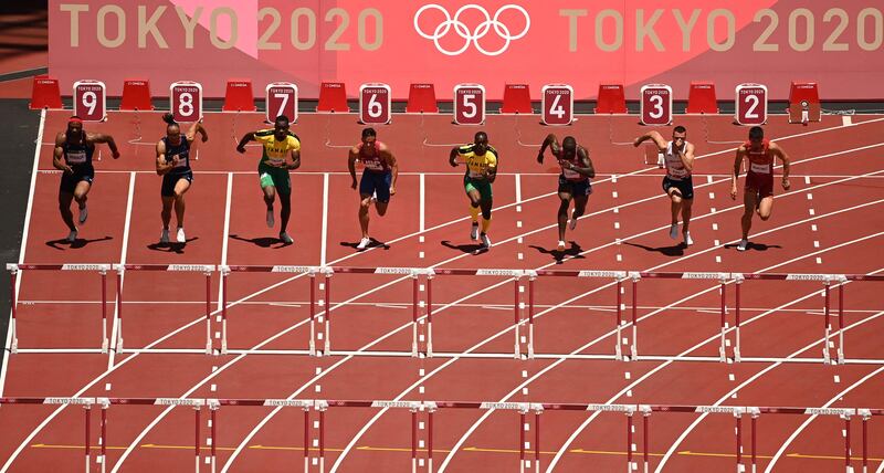 Runners sprint out of the blocks in the men's 110m hurdles final.