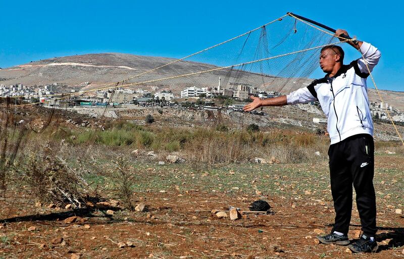 Palestinian men hunt birds on the outskirts of the West Bank city of Nablus.  AFP