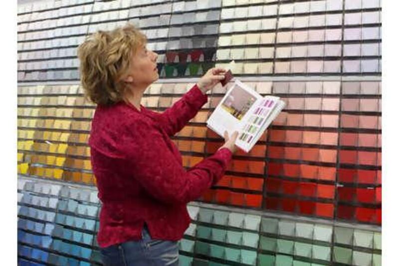 Julie Meer looks through colour samples as she tries to decide which paints to choose for her new wellness centre in Dubai.