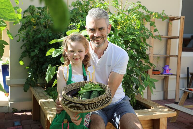 Amirah Carroll, 5, and her father, Jamie, an air-traffic controller from Ireland who taught his daughter how to grow vegetables. Nilanjana Gupta / The National