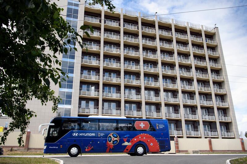 The Switzerland team bus drives in front of the Lada Resort Hotel, Switzerland's team base camp, in Togliatti, Russia. EPA