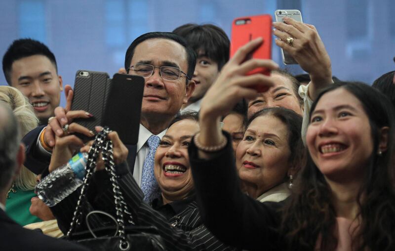 Thailand's Prime Minister Prayut Chan-o-cha, second from left, is swarmed for selfies after a speech at the Asia Society, during his visit to the United Nations General Assembly in New York. AP Photo