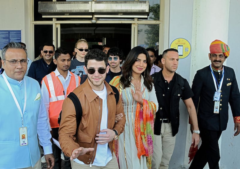 Bollywood actress Priyanka Chopra and singer Nick Jonas wave as they arrive at the airport in ahead of their wedding on November 29, 2018. Photo: Reuters