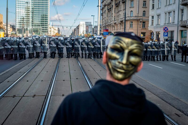 Police clash with participants of a demonstration against coronavirus restrictions in Warsaw, Poland. AFP