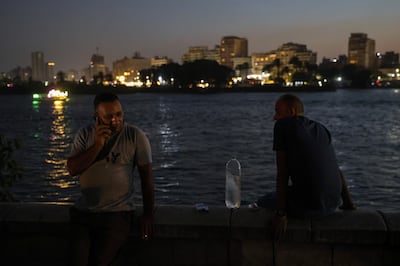 People cool off by the River Nile at night during high temperatures in Cairo, Egypt. Bloomberg. 