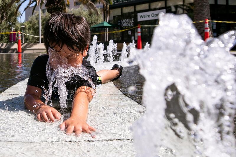 A child plays in the water of the Arthur J. Will Memorial Fountain in front of City Hall as a heatwave strikes in Los Angeles, California, USA. EPA