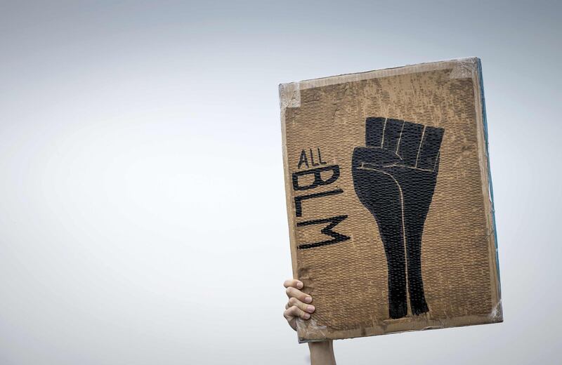 A protester holds a placard during an anti-racism demonstration in Deventer, The Netherlands.   AFP