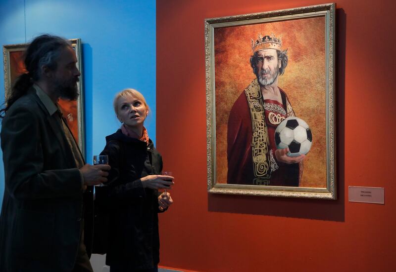 Visitors speak in front of portrait of Eric Cantona at the Museum of Academy of Arts in St.Petersburg, Russia. Dmitri Lovetsky / AP Photo