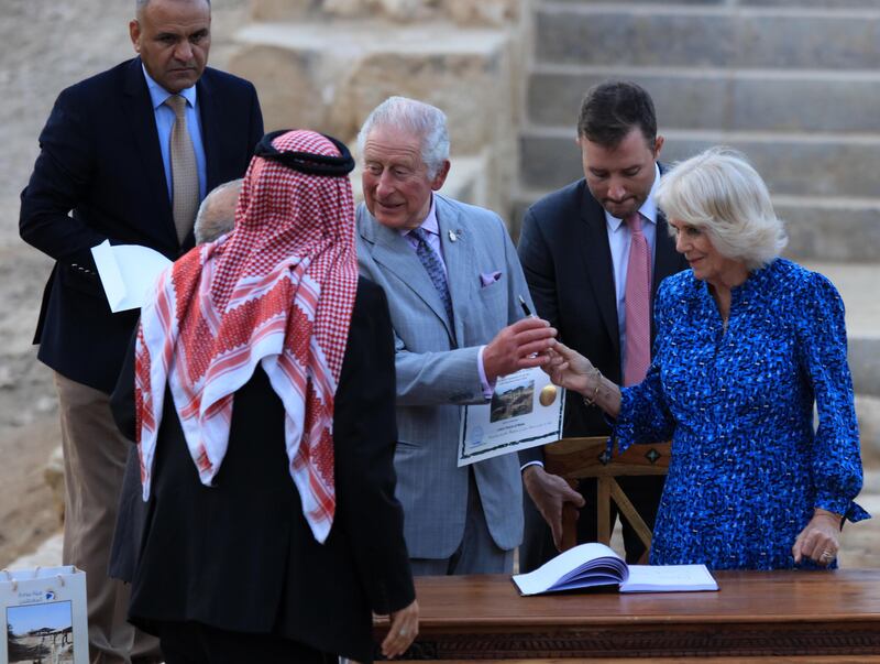The royals sign the guest book in Al-Maghtas. EPA