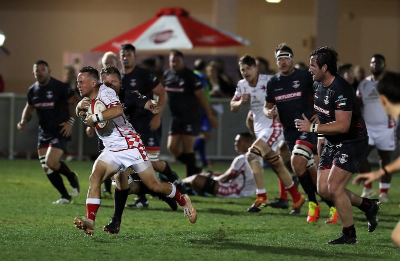 Abu Dhabi Harlequins attempt to break away with the ball against Dubai Exiles.